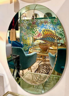 An Italian 1960s Crystal Arte oval mirror with pastel mint green mirrored frame