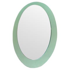 An Italian 1960s Crystal Arte oval mirror with pastel mint green mirrored frame