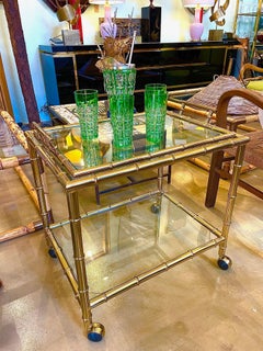 An Italian 1970s faux bamboo brass bar trolley with removable top tray