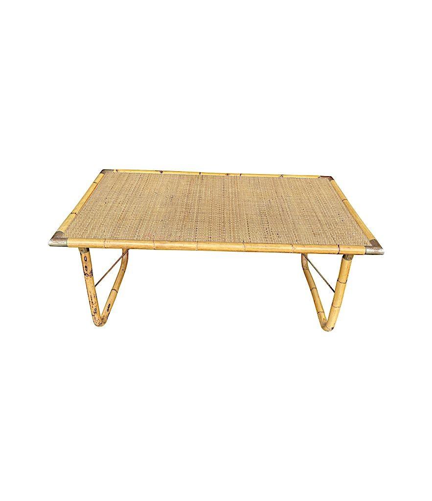 An Italian 1970s folding bamboo coffee table by Del Vera with gilt metal corners and rattan top.