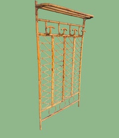An Italian 1970s full length bamboo coat and hat rack with top shelf.