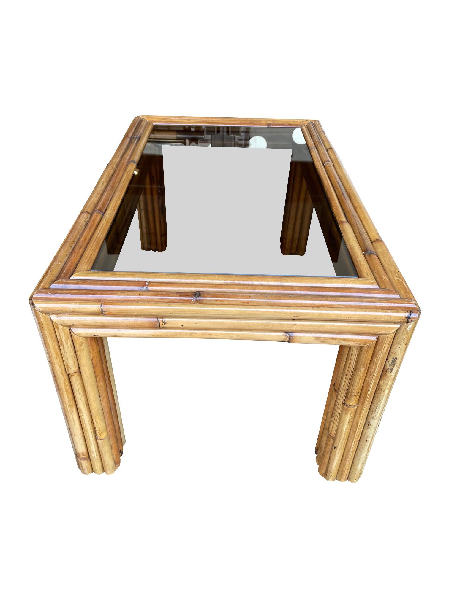 An Italian 1970s bamboo coffee table with original smoked glass top.