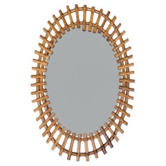 An Italian 1970s oval split cane bamboo mirror by Franco Albini