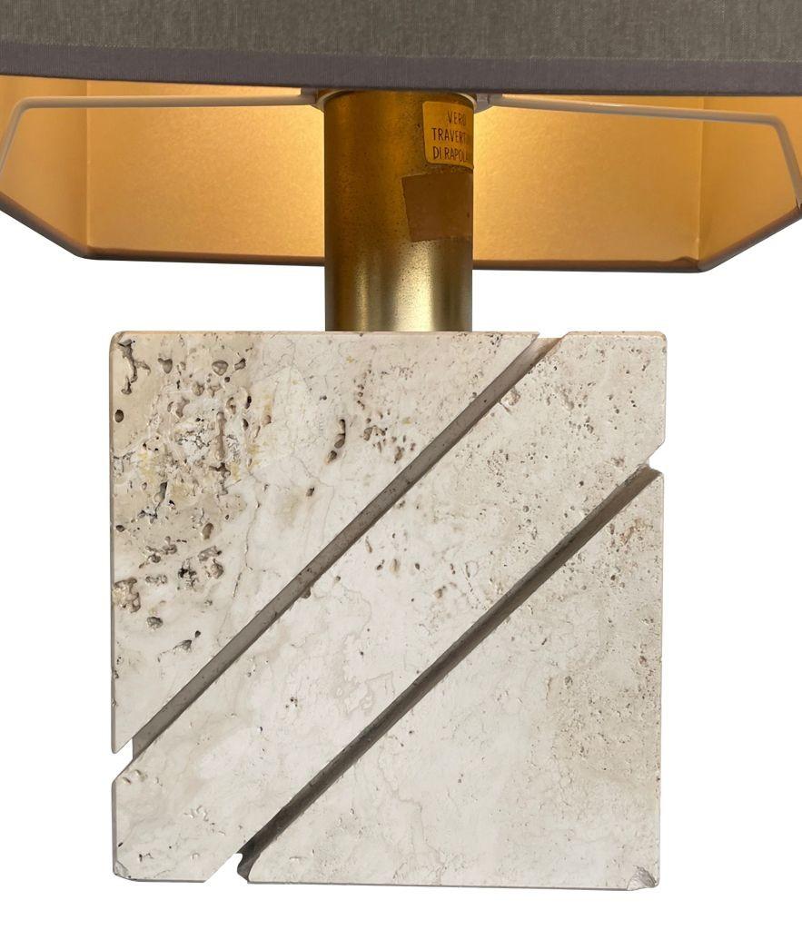 An Italian 1970s travertine and brass lamp by Fratelli Manneli with diagonal grooved detail, new brass fittings, antique cord flex and PAT tested.