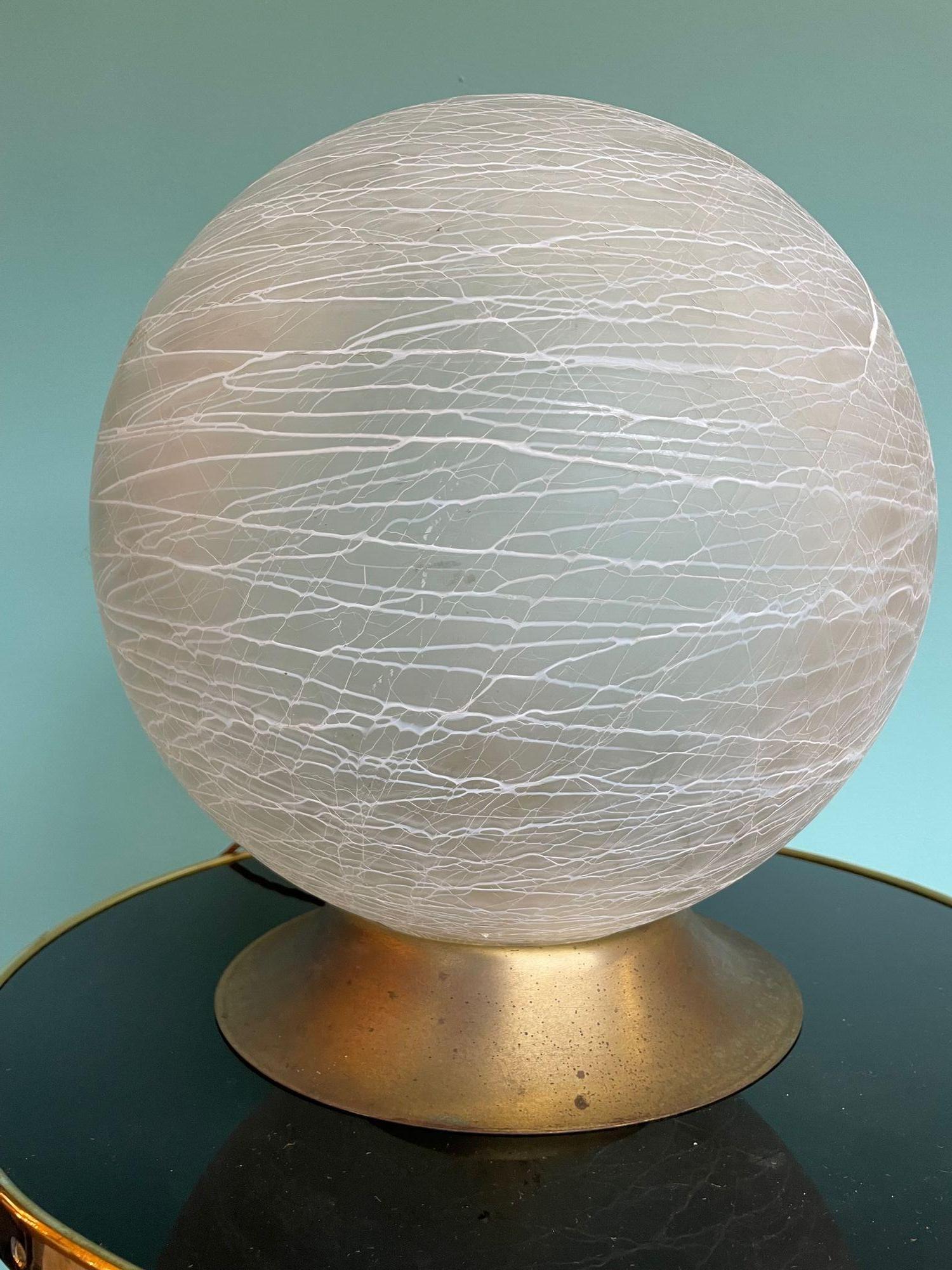 An Italian 1970s Venini Murano glass swirl ball lamp on brass base, re wired with new fittings, antique gold cord flex and switch.