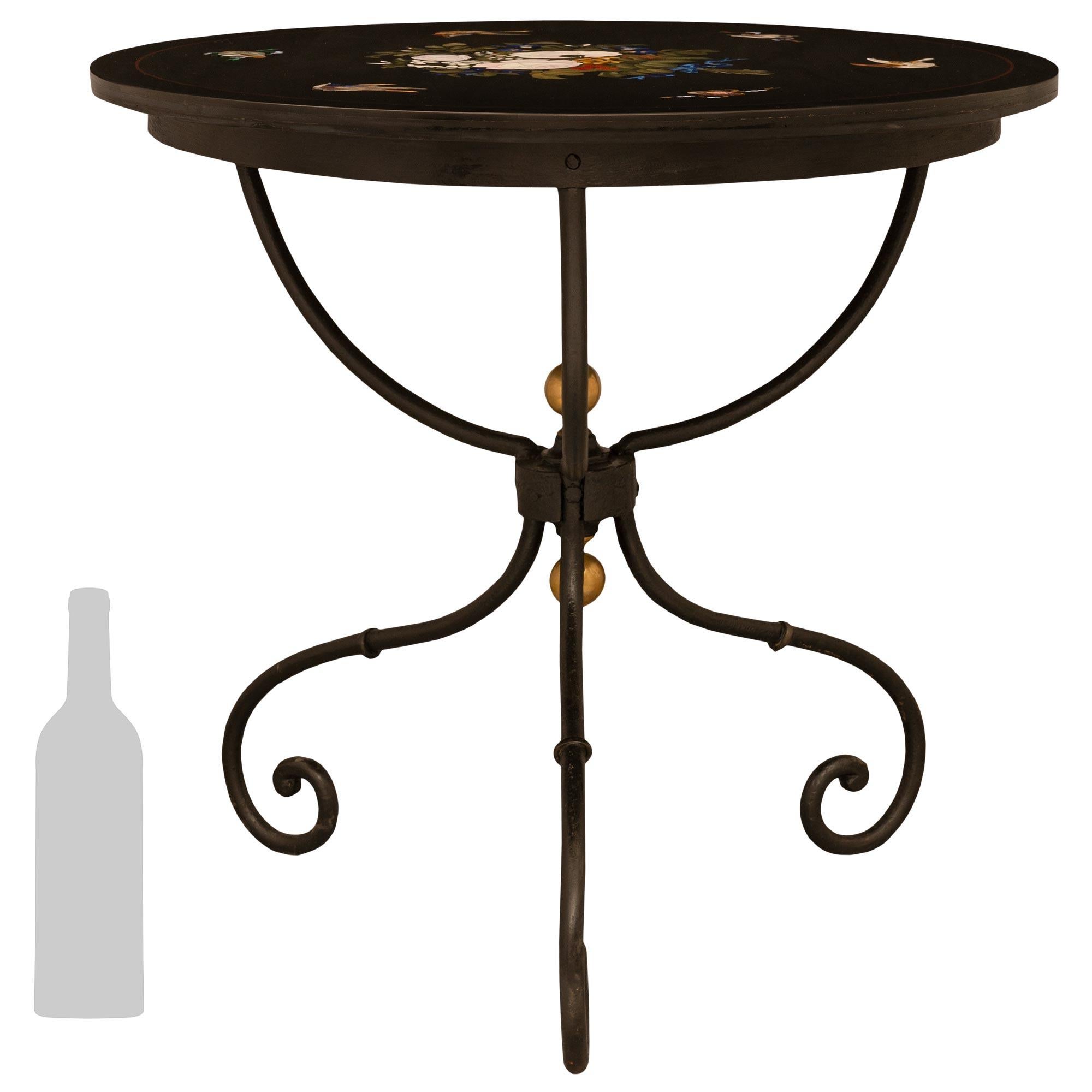 A very decorative Italian 19th century Florentine st. Wrought Iron, brass and marble side table. The table is raised on a scrolled Wrought Iron base joined in the center by a handsome Wrought Iron stretched adorned with a top and bottom brass ball