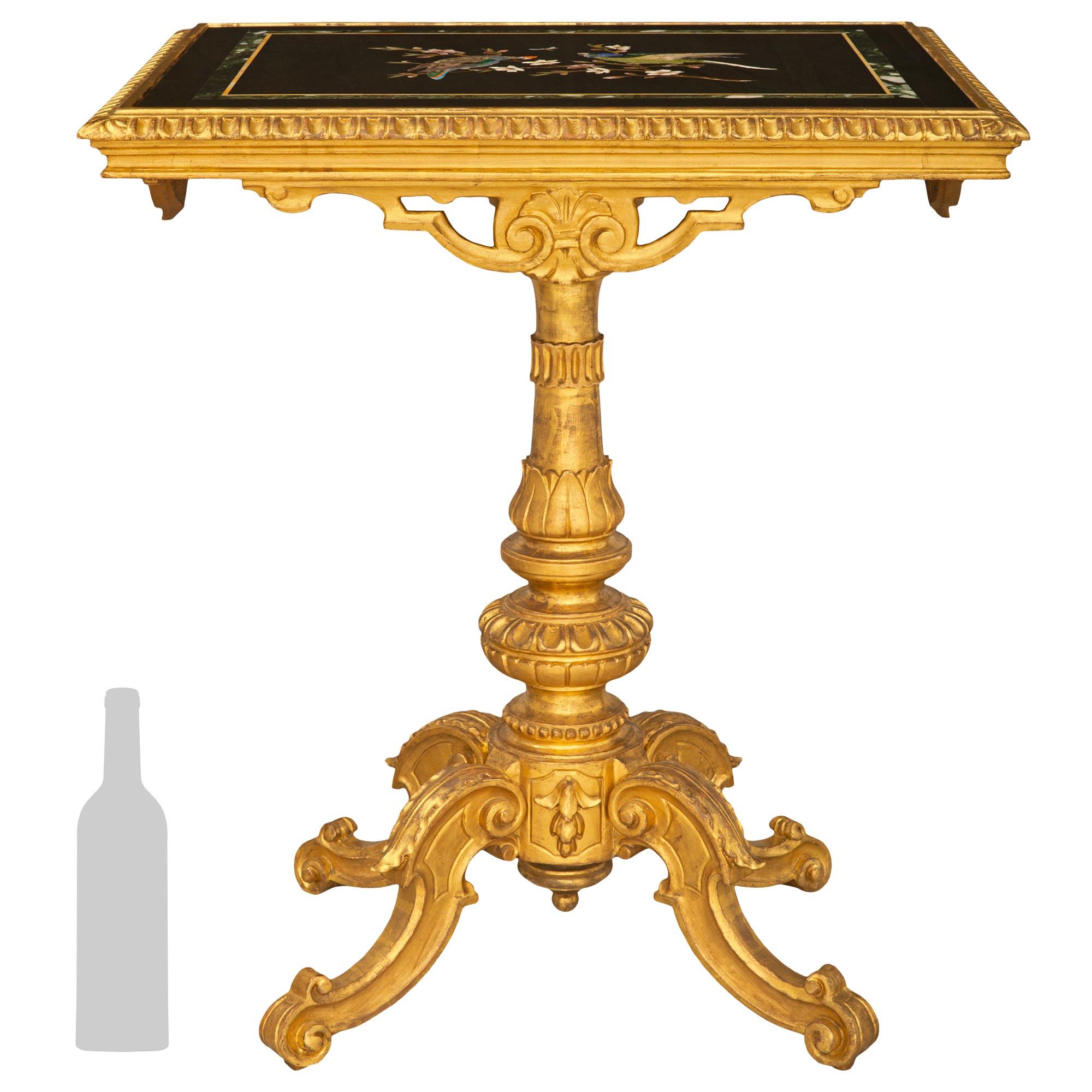 A stunning Italian 19th century Florentine st. Giltwood and Pietra Dura marble side table. The tilt top table is raised by a four scrolled legs with bottom scrolls and attractive elongated top acanthus leaves. The central column supporting the top