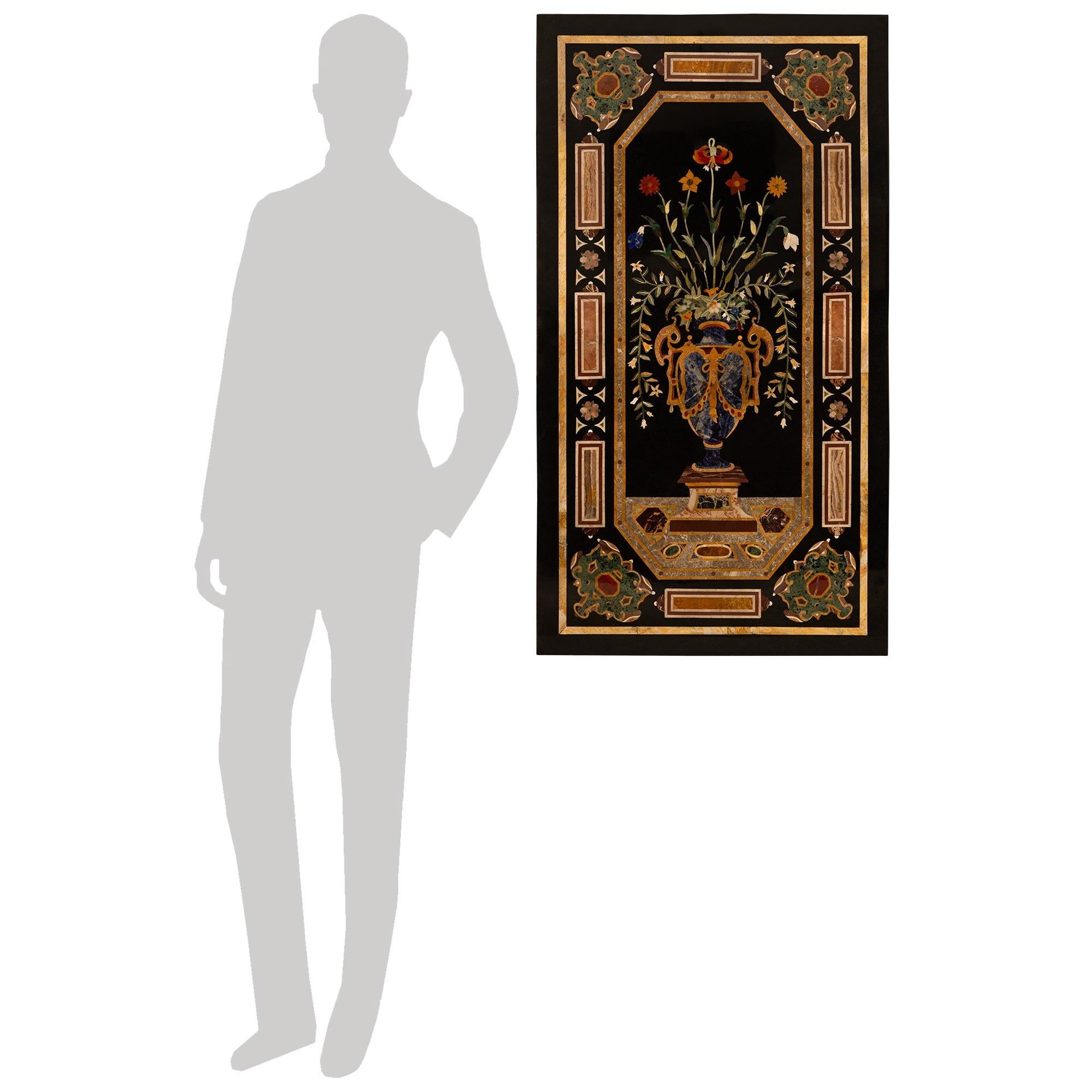 An impressive and most decorative Italian 19th century Pietra Dura Marble plaque/wall decor. This stunning rectangular plaque is set on a black Belgian marble background. The plaque displays exceptional intricately detailed inlaid blooming flowers