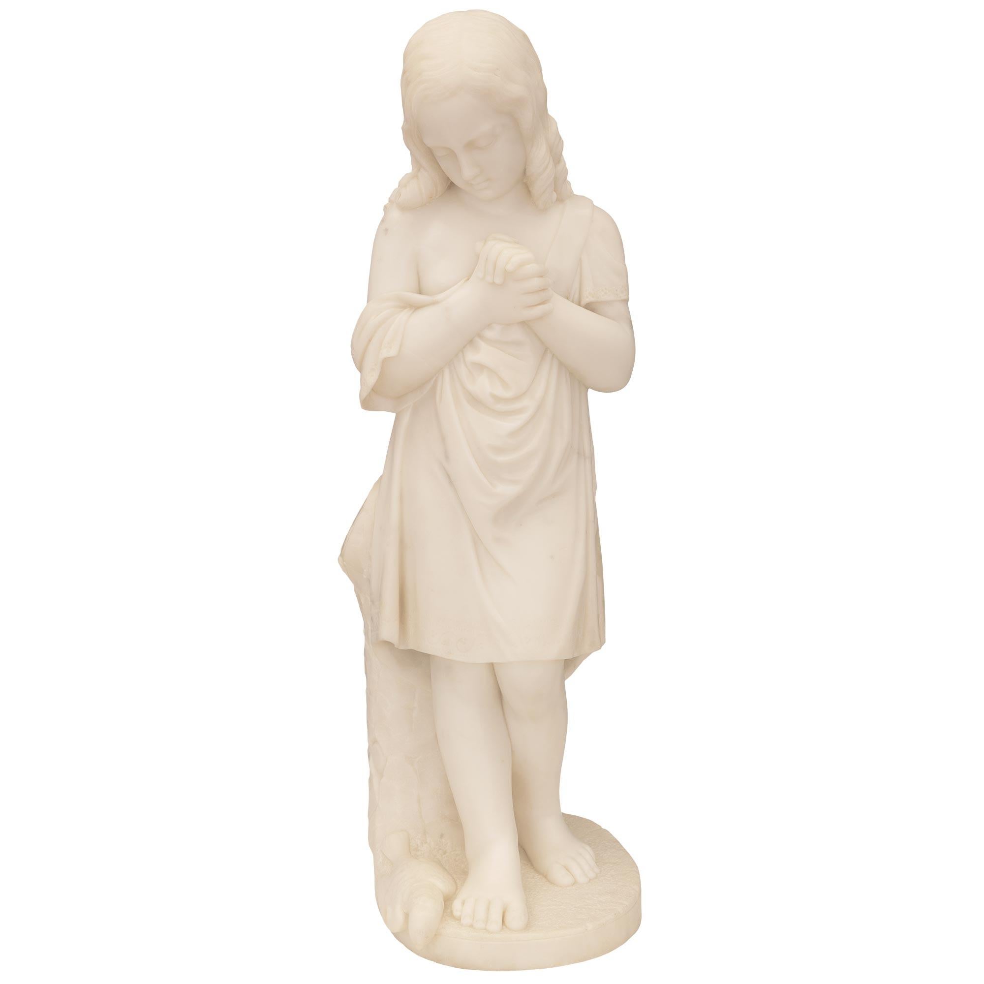 Exceptionnelle statue italienne du XIXe siècle en marbre blanc de Carrare. La statue représente une jeune fille pleurant la mort de son oiseau de compagnie. La statue est surélevée par une base oblongue avec un fin motif au sol où l'oiseau tombé