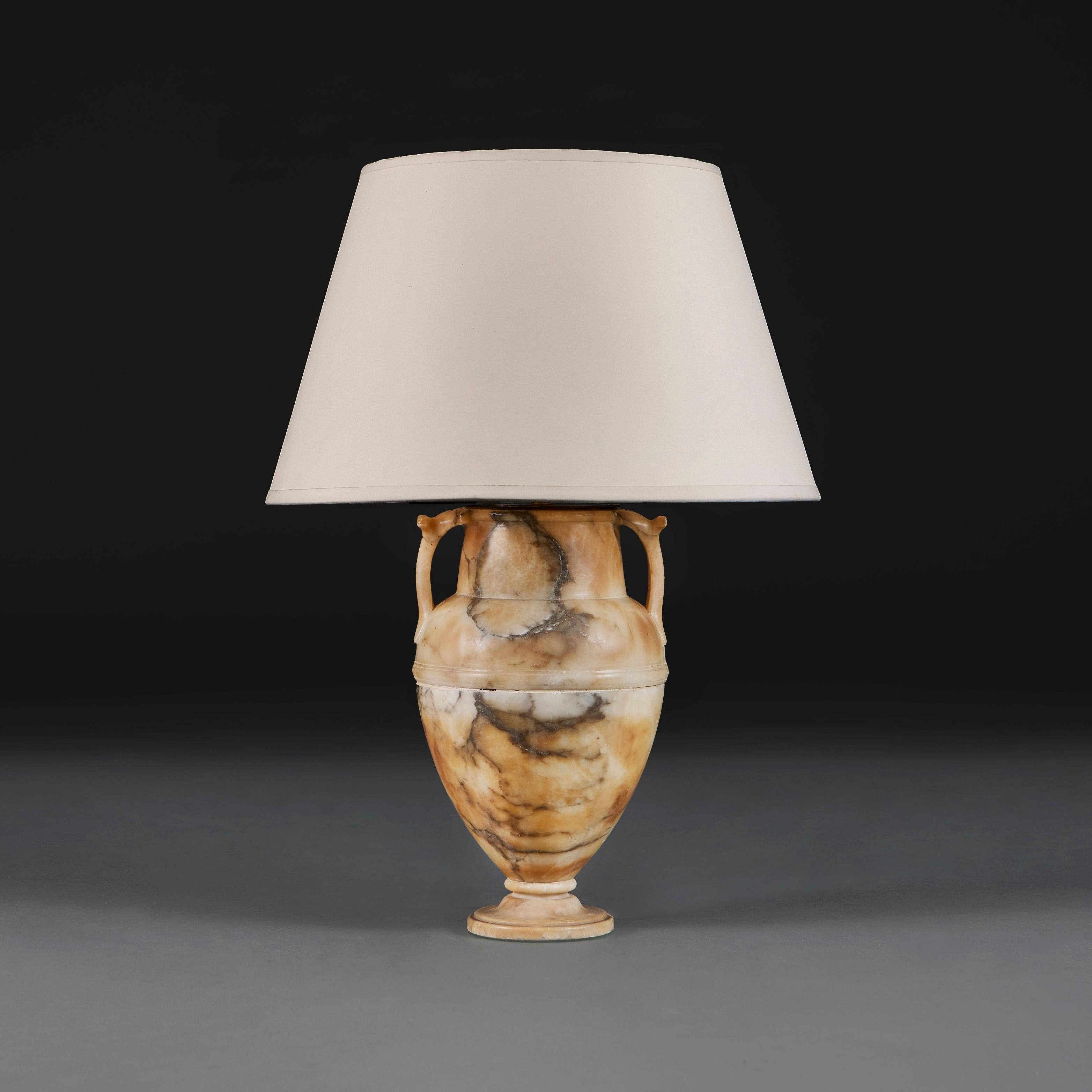 Italy, circa 1850

A mid nineteenth century alabaster urn with grey veining and curved handles, now mounted as a lamp.

Height of urn 29.00cm

Diameter 18.00cm

Photographed with a 16” diameter Pembroke card lampshade.

Please note: This is