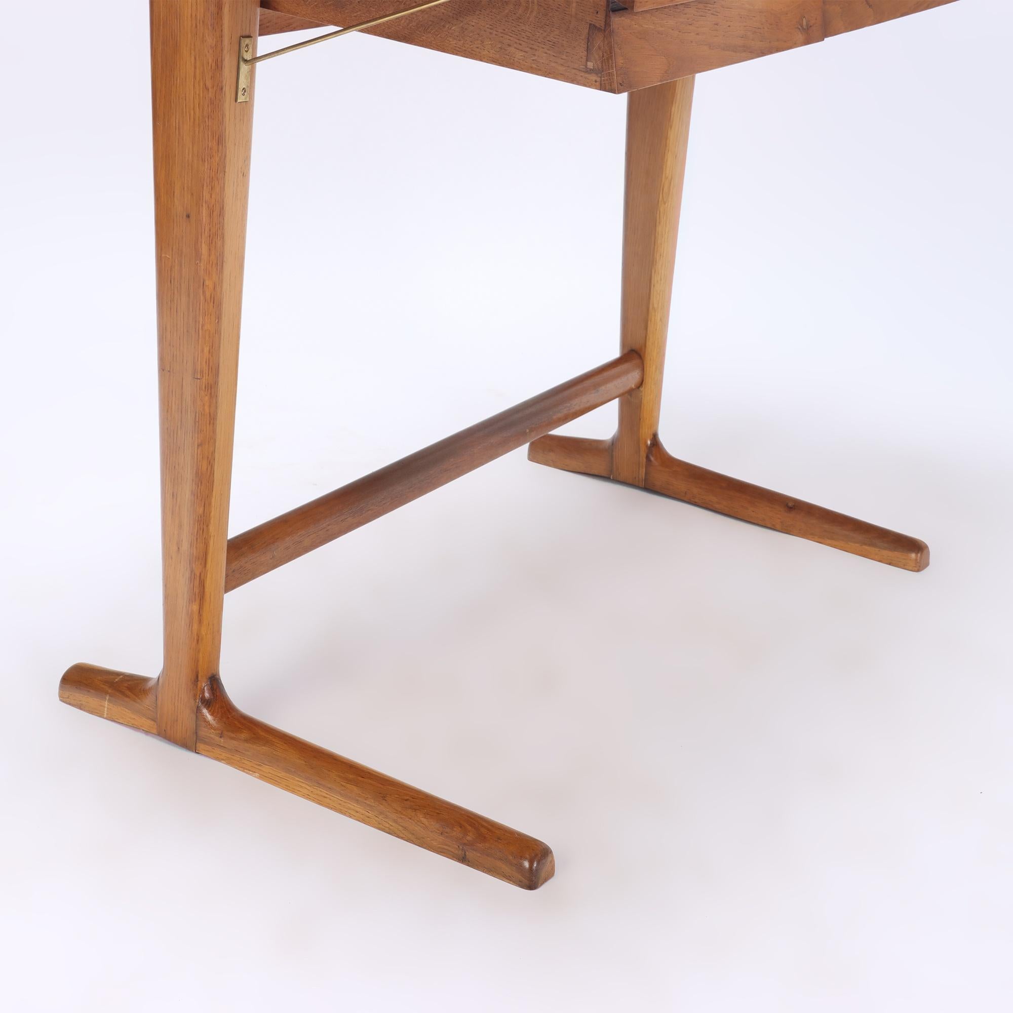 An Italian Architect's desk made with a slant, supported by an oak base and with a black glass top, circa 1960.