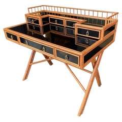 An Italian bamboo brass and black laminate desk with drawers and galleried top