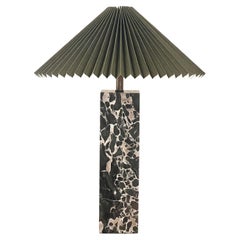An Italian black marble table lamp with Danish pleated abat-jour shade, 20th c.