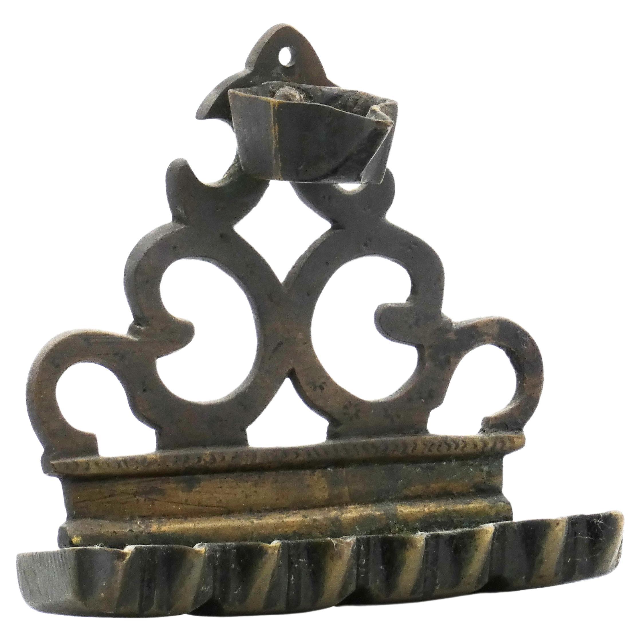 North African cast brass Hanukkah Lamp Menorah, mid 19th century

There are two sources for the triangular, small-scaled Hanukkah lamp, one in Spain, the other in Sicily. This lamp represents the prototype from Sicily, which migrated as far as
