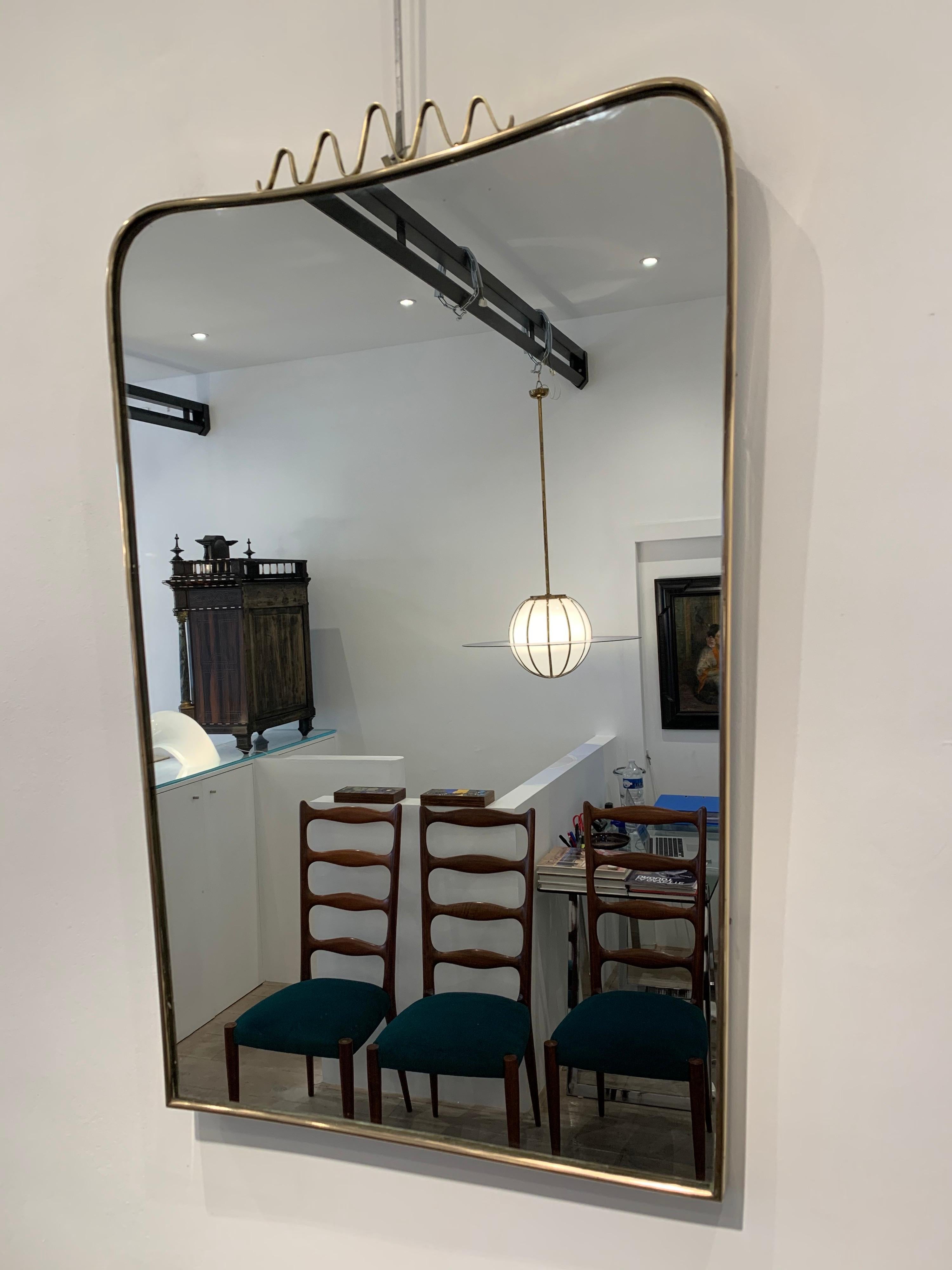 This type of brass mirrors were popular in the 1940s. Gio Ponti designed some of the models. This particular is of the period.