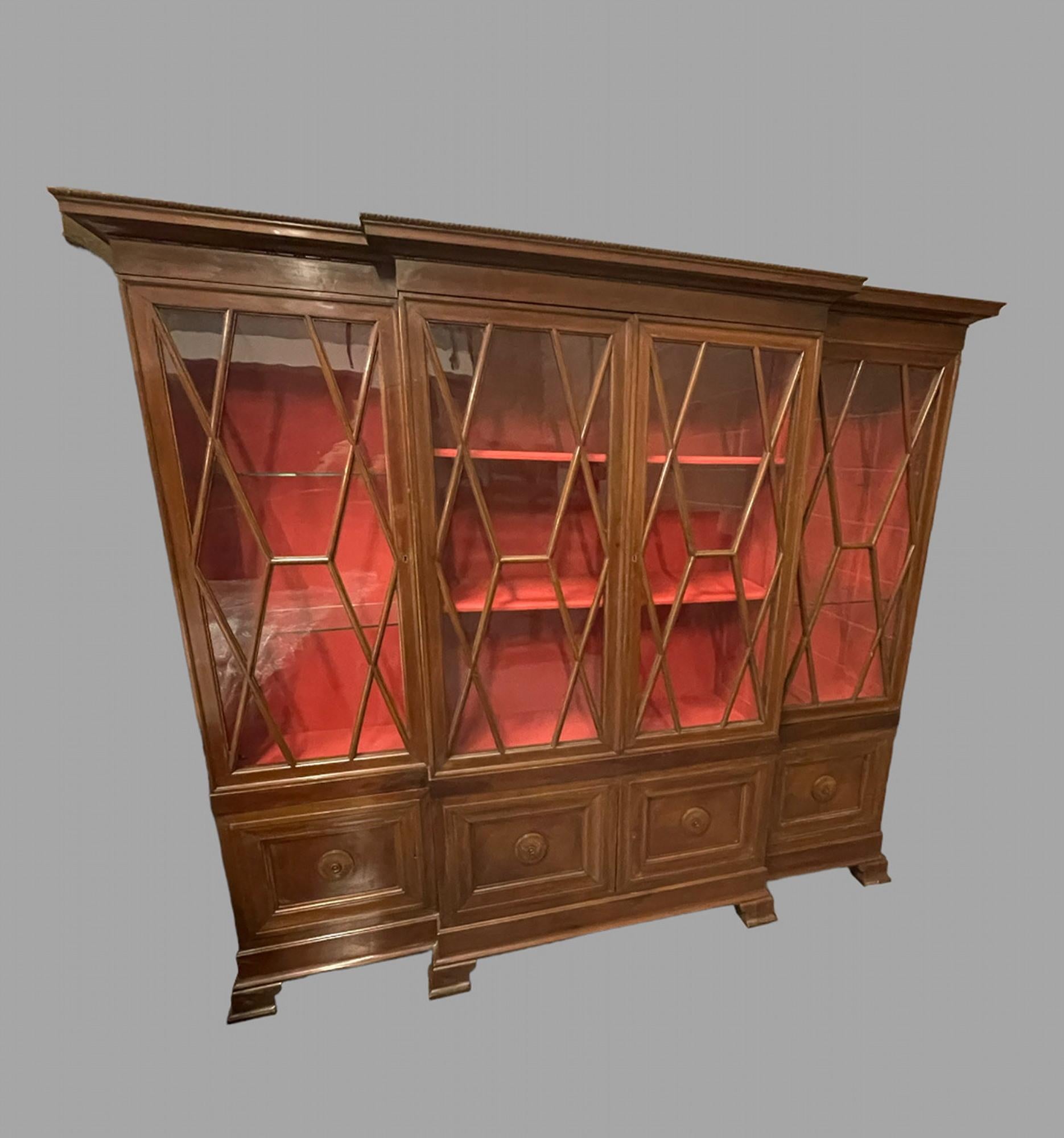 This is an attractive Italian breakfront bookcase of Italian origin and dating from the Early 20th Century, Circa 1920, this bookcase is influenced by English breakfront bookcases of the Early Nineteenth Century. The glazed doors enclose an