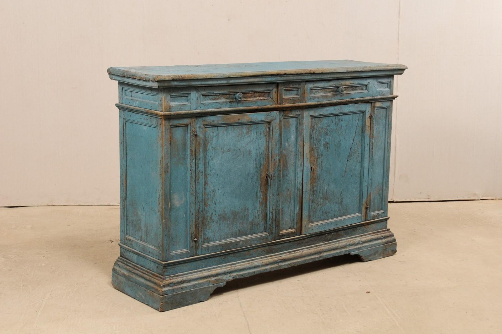An Italian painted wood buffet cabinet from the 19th century, with later additions. This antique storage cabinet from Italy features a slightly overhanging rectangular-shaped top, above a case with two smaller sized drawers set horizontally at top,