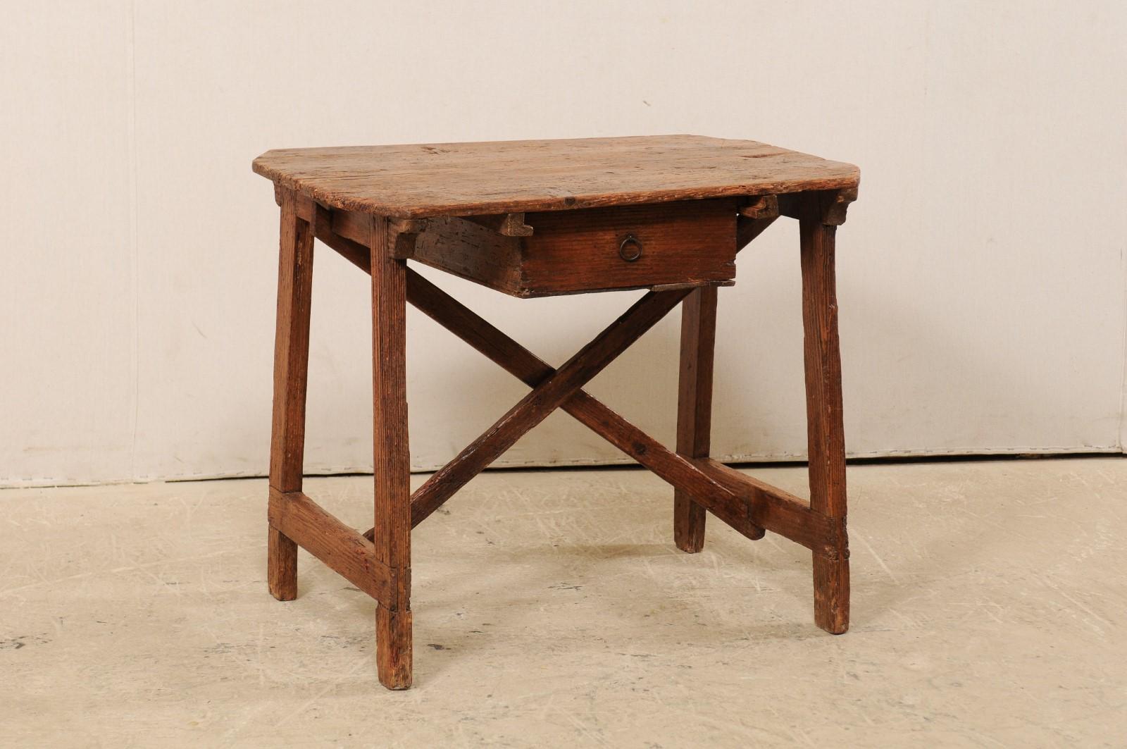 An Italian smaller-sized wooden work bench table with drawer from the 19th century. These cute little antique tables from Italy, often referred to as a 