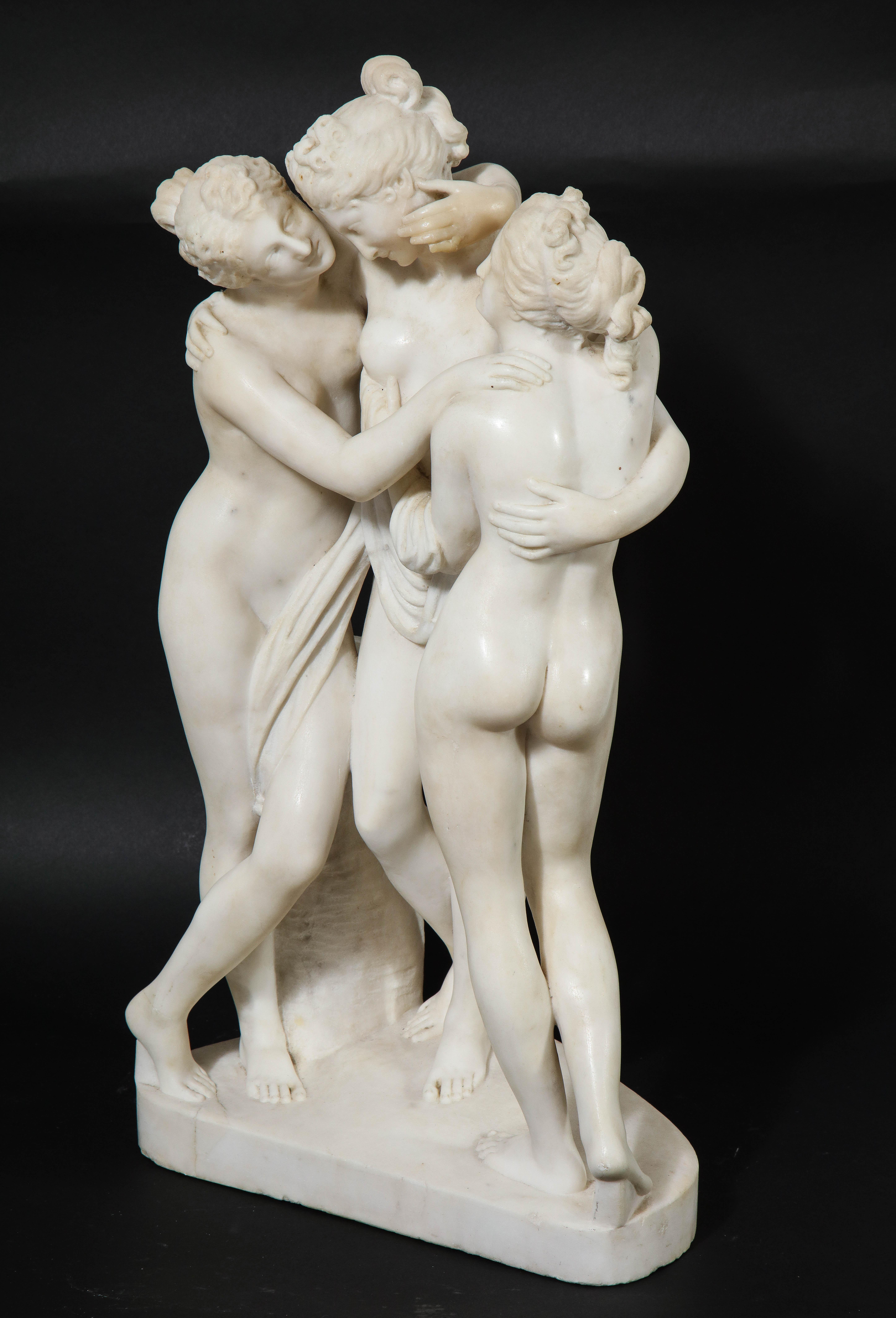 An Impressive 19th Century Italian Hand-Carved Carrara Marble Model of The Three Graces, Originally by Antonio Canova.  The carving on this piece is exceptionally well done.  The faces, hair, hands and draped clothing on the graces are all