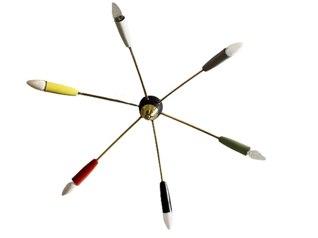 An Italian ceiling lamp from the 60s.
 
6 Brass arms lamp with different colored fittings
Showed with 2 different color light bulbs (not included)

Measures 11 cm high and 71 cm diagonal
The weight is 772 gram.
