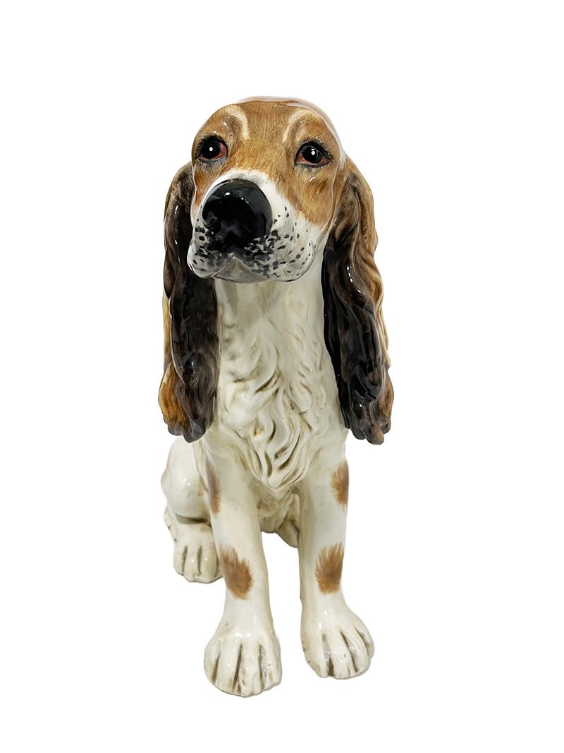 An Italian ceramic cocker spaniel, 1970s.

A ceramic very cute cocker spaniel of 38 cm high, made in Italy, during the 70s. 
Hand painted dog figurine with hair of the dog painted with brushstrokes. A cream-colored ceramic with brown and black