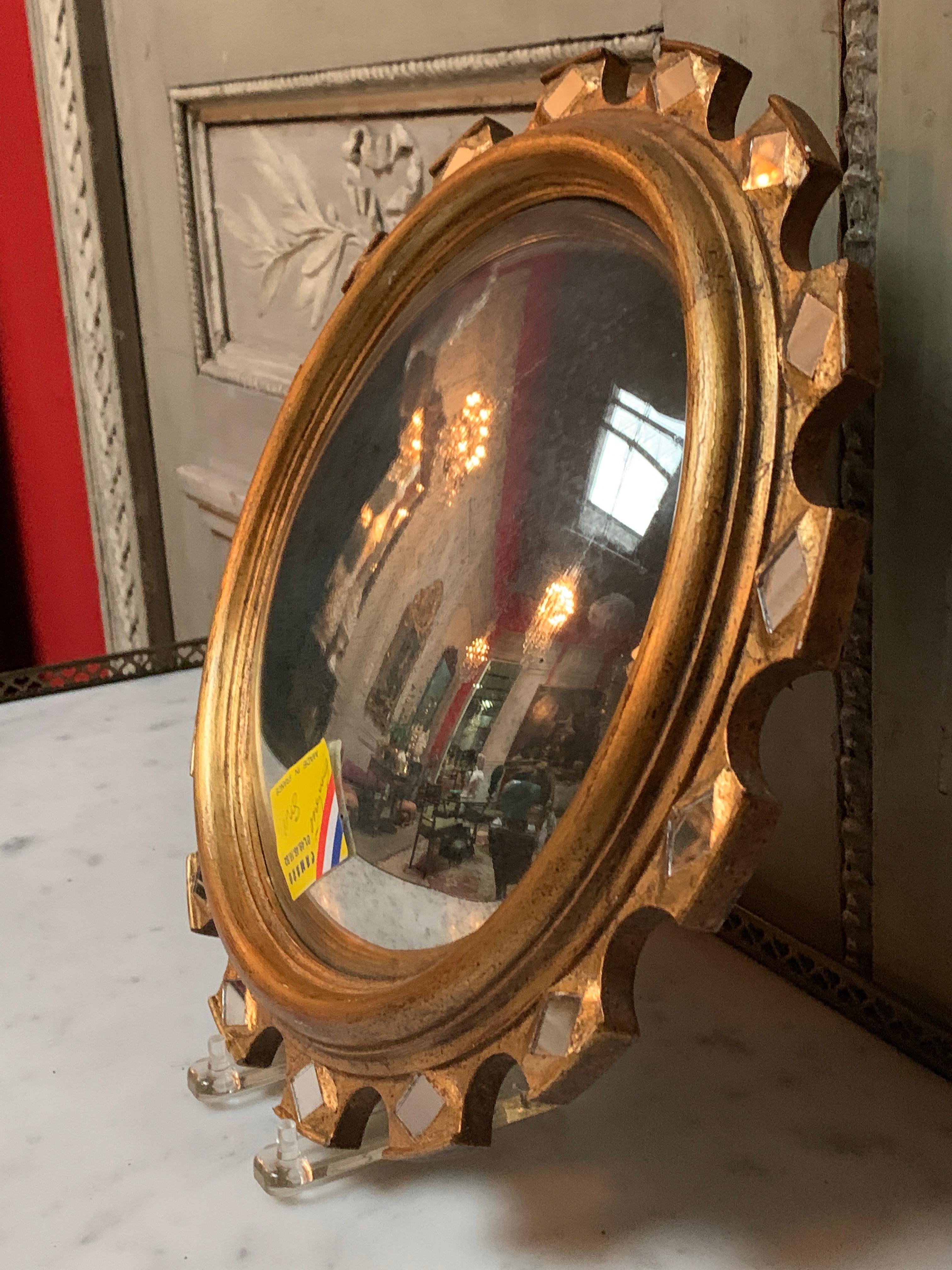 A small Mid-Century Italian gilt-wood convex starburst mirror.  This stylish mirror has an elegant scallop edge with a diamond mirror inlay pattern. 