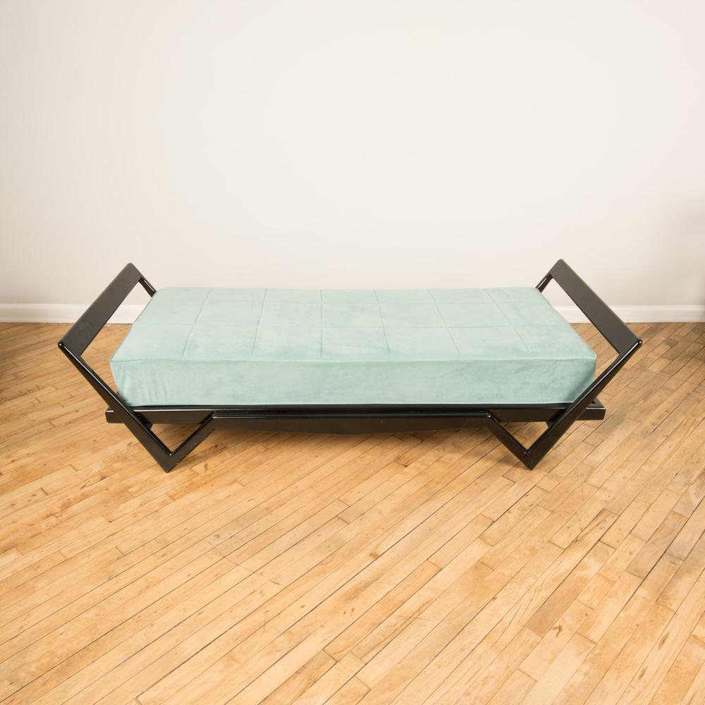 An Italian ebonized day bed with blue cushion in the manner of Ico Parisi, circa 1950.