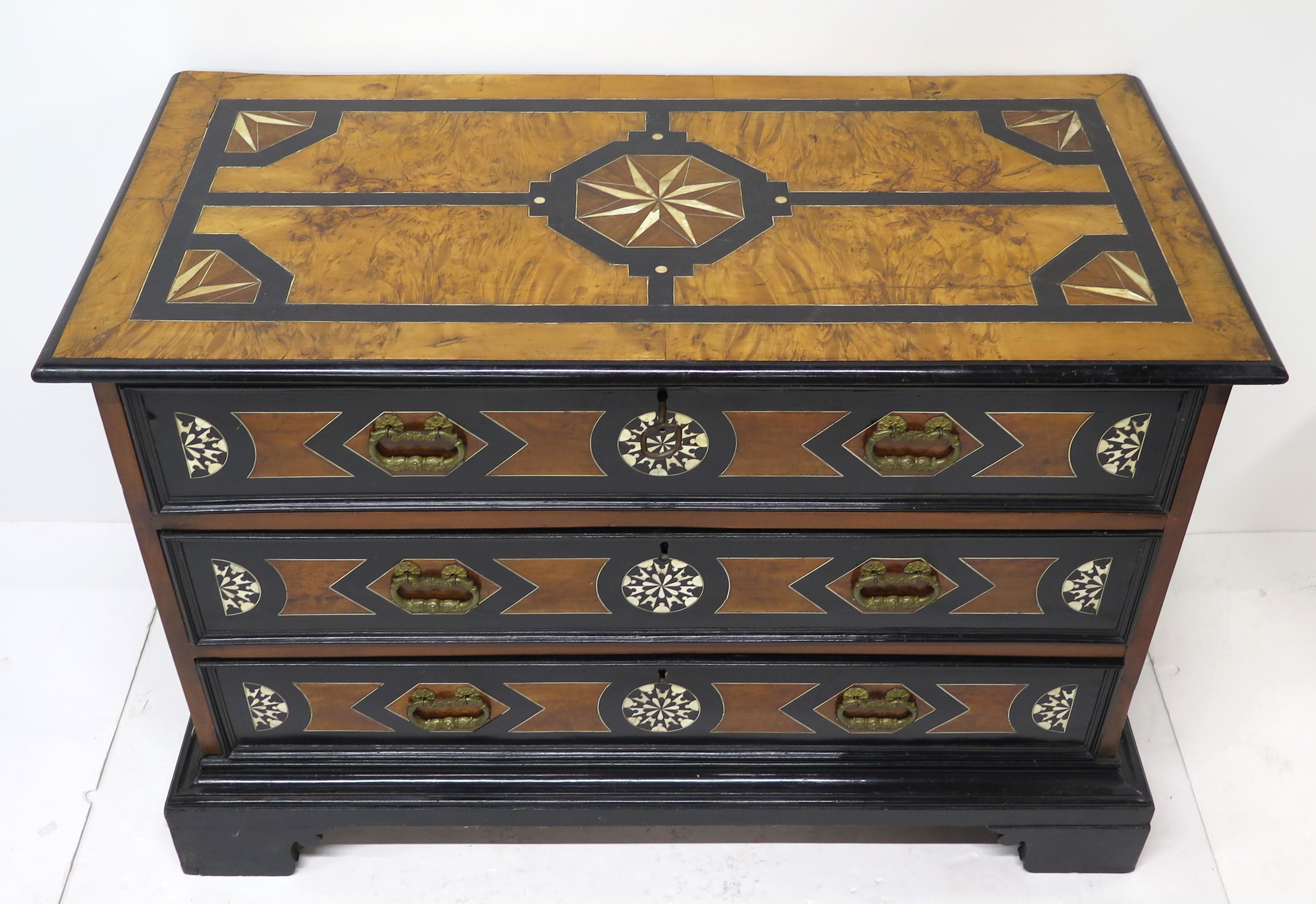 an early 18th century Italian ebonized fruitwood and bone inlaid three drawer commode, with overall geometric inlay design, possibly Milan, circa 1720

lable in drawer 
