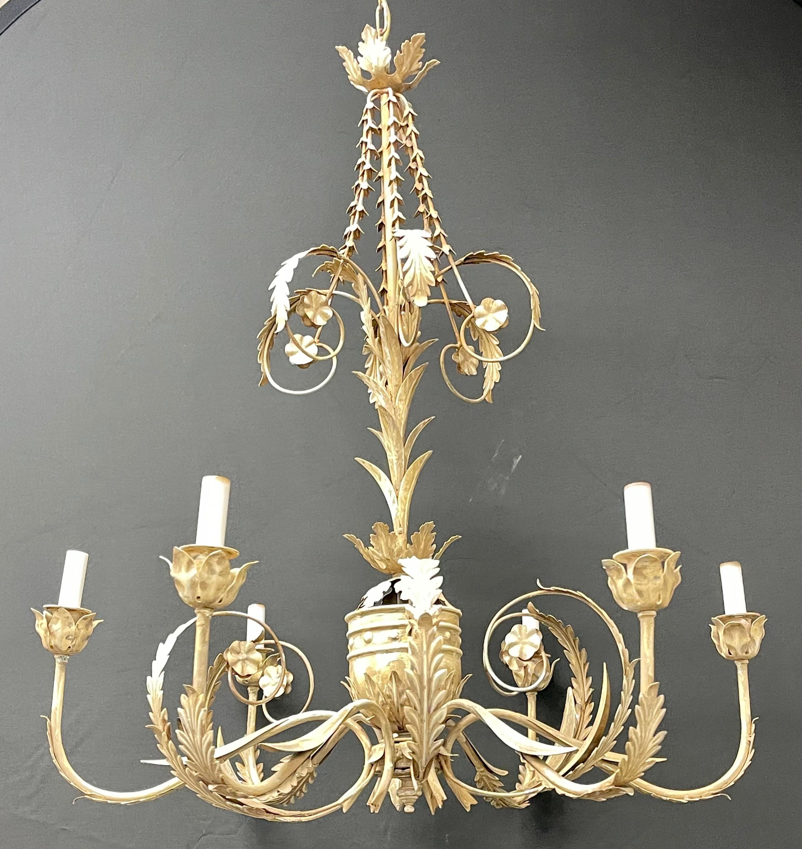An Italian gilt metal chandelier having six lights. The base having flowing roses and vines on a solid center stem.

Height: 36 in.
Diam: 30 in.