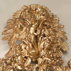 An Italian Giltwood Mirror Carved with Allegorical Figures of the Seasons