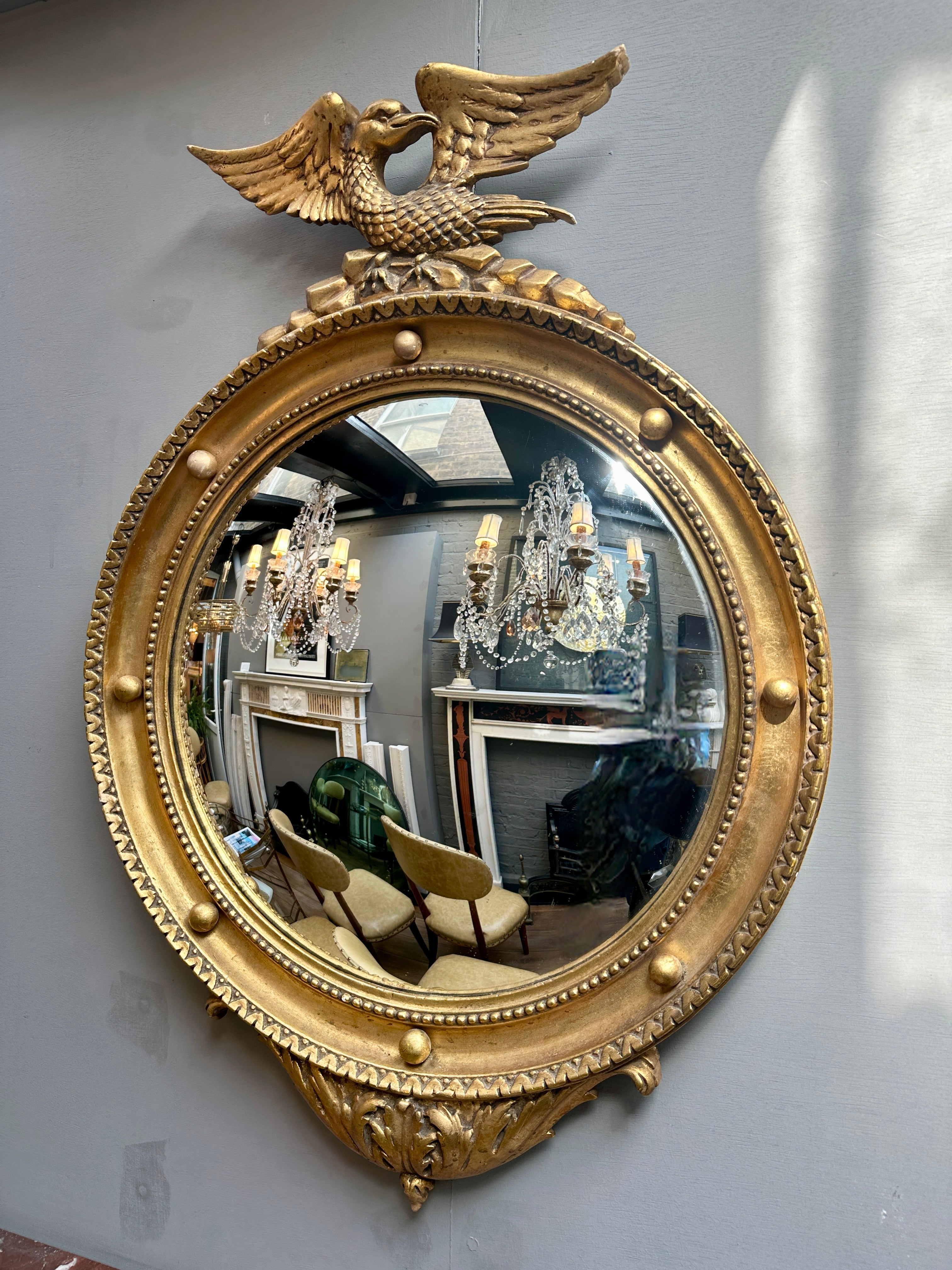 An Italian Regency style gold gilt creste mirror circa 1950. Labelled to back by C Allodi G Subelli  Cremona 

The eagle crested above with decorative edge, beeded inner slip, ball decoration spaced out between the frame. 

A good quality mid 20th