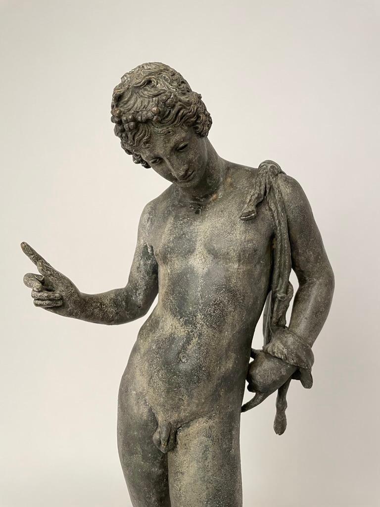 A Neapolitan Grand Tour bronze figure of Narcissus, after the original sculpture excavated in 1862 at Pompeii, third quarter 19th century. Narcissus is shown naked, with only an animal skin slung over his should. He is pausing mid-stride, gazing
