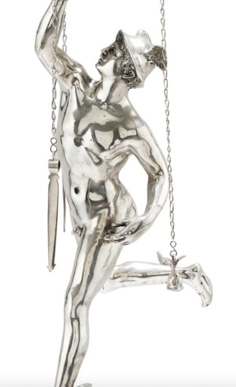 An Italian grand tour silver table library lamp depicting mercury, Rome, circa 1830, after the Antique.

With Italian silver hallmarks and makers marks throughout.

The stem representing the Giambologna Mercury, resting on a cylindrical base in