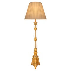An Italian late 18th century Baroque st. patinated and Giltwood lamp