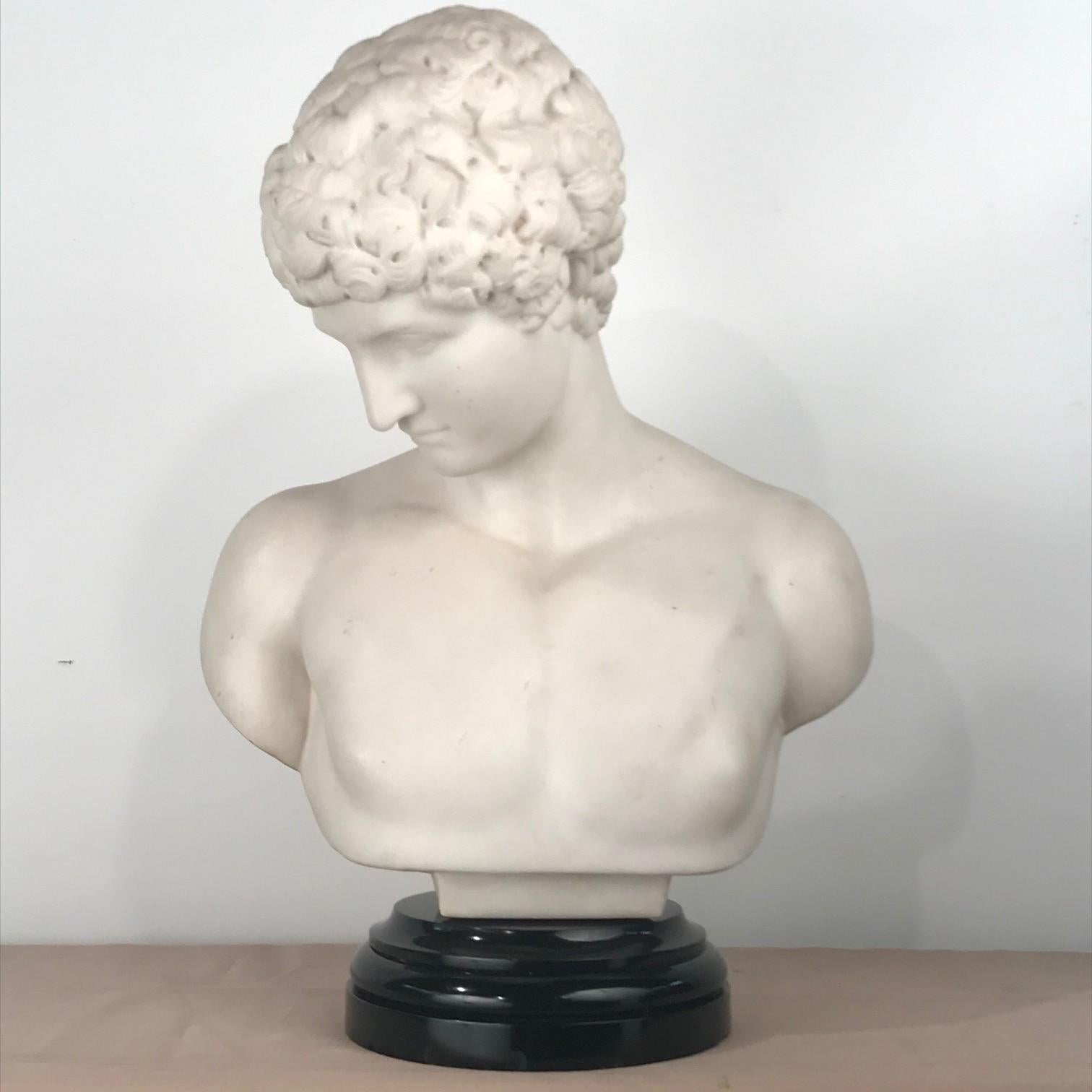 The elegant features of the young Antinous, a favourite of beloved Roman emperor Hadrian, are masterfully captured with exceptional richness in this marble bust of this beautiful boy. The lifelike details of his handsome face, with a straight nose