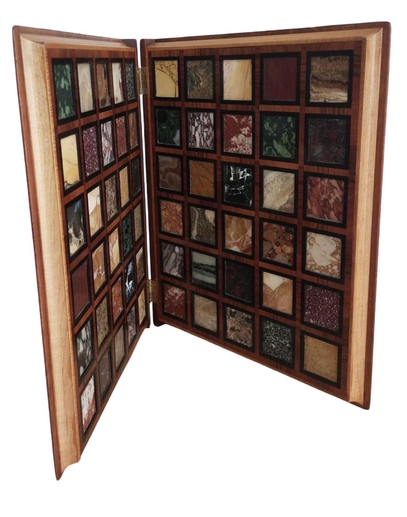 The cover inlaid with the title 'COLLECTIO MARMORUM' incorporating ebony, tulipwood and mahogany. The hinged wooden book having the appearance of gold pages and opening to reveal a total of 60 samples of Italian and Exotic marbles on each side.