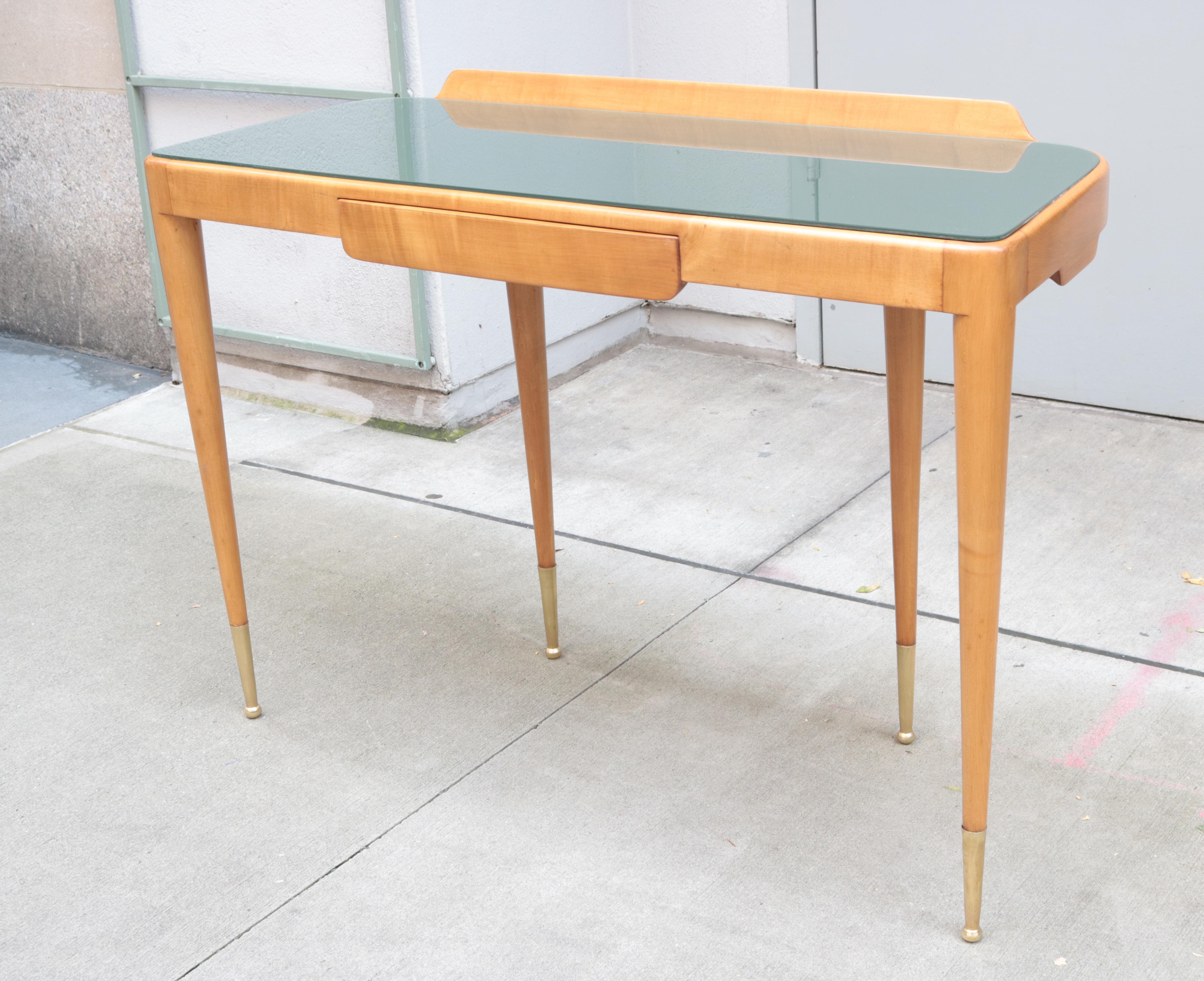 An Italian modernist console with single drawer.
Fruitwood with glass top and brass sabots.