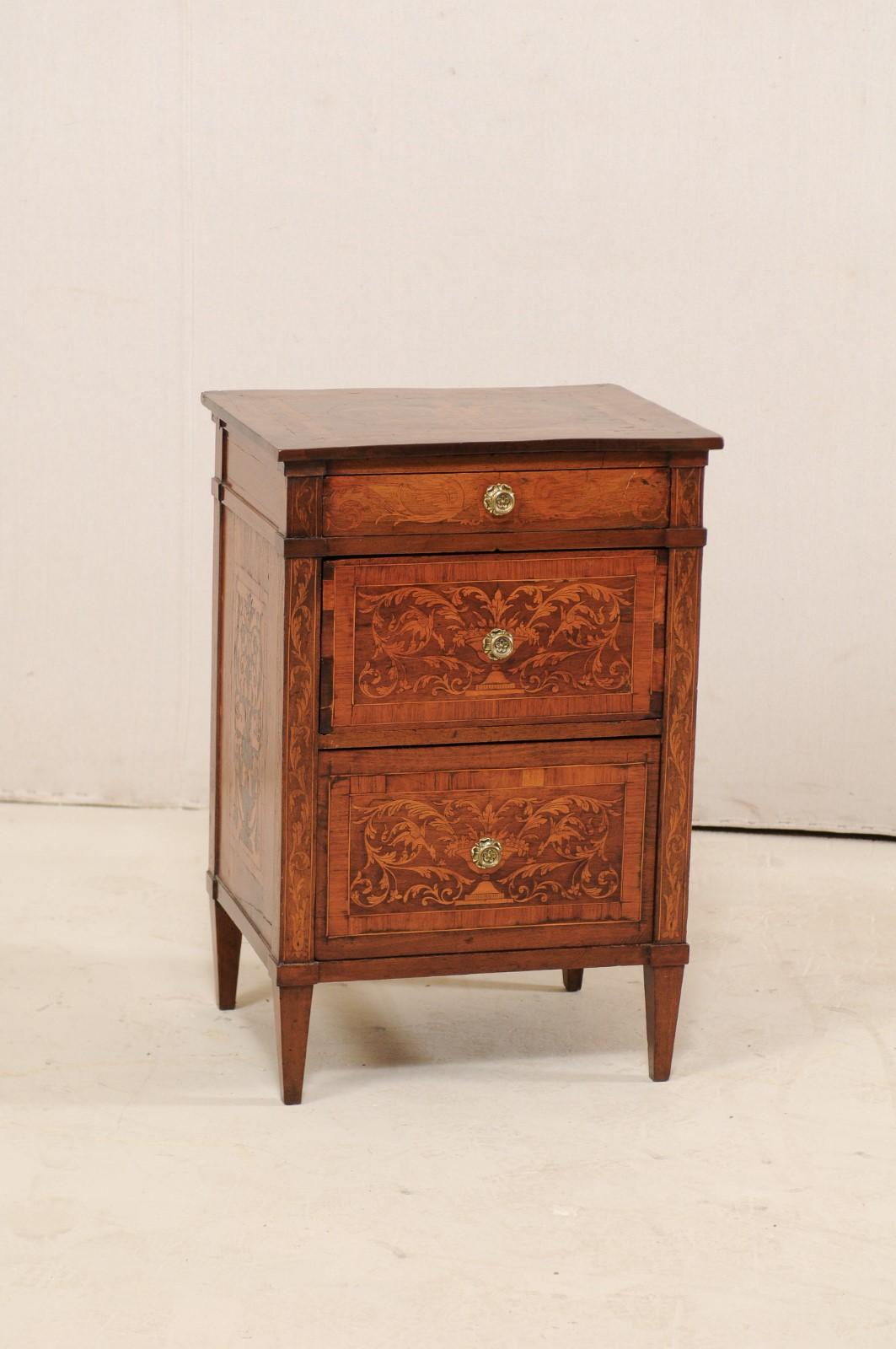 An Italian small-sized neoclassical commode with refined decorative inlay from the early 19th century. This antique chest from Italy is decorated at top, front side post, three drawer fronts and each side with beautiful banding and elegantly inlaid