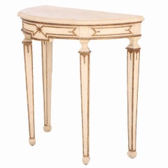 An Italian Neoclassical style painted and giltwood console table and mirror.