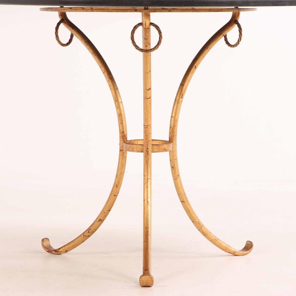 The round marble top adorned with typical, but highly detailed, Scagliola type painted embellishments, supported by a painted iron tripartite base with scrolling feet.