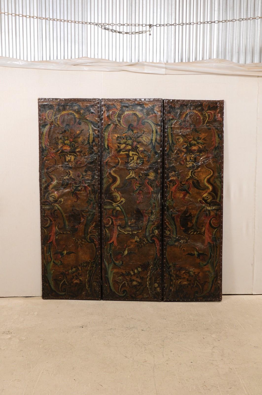 A fabulous Italian pair of 7 ft. tall leather embossed folding screens from the turn of the 17th and 18th century. This pair of antique accordion style folding screens from Italy each features three connected panels, each rectangular in shape, whose