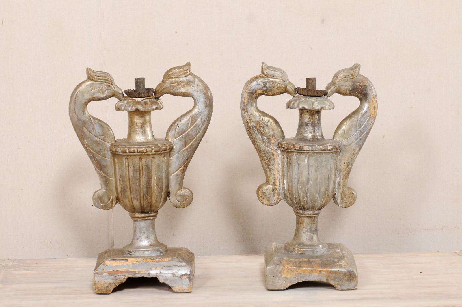 A pair of Italian carved-wood urns, with single candlestick, in bird motif, from the 19th century. These antique single-candlestick holders from Italy each feature three-dimensionally carved urn, with fluted embellishments, and having two handles