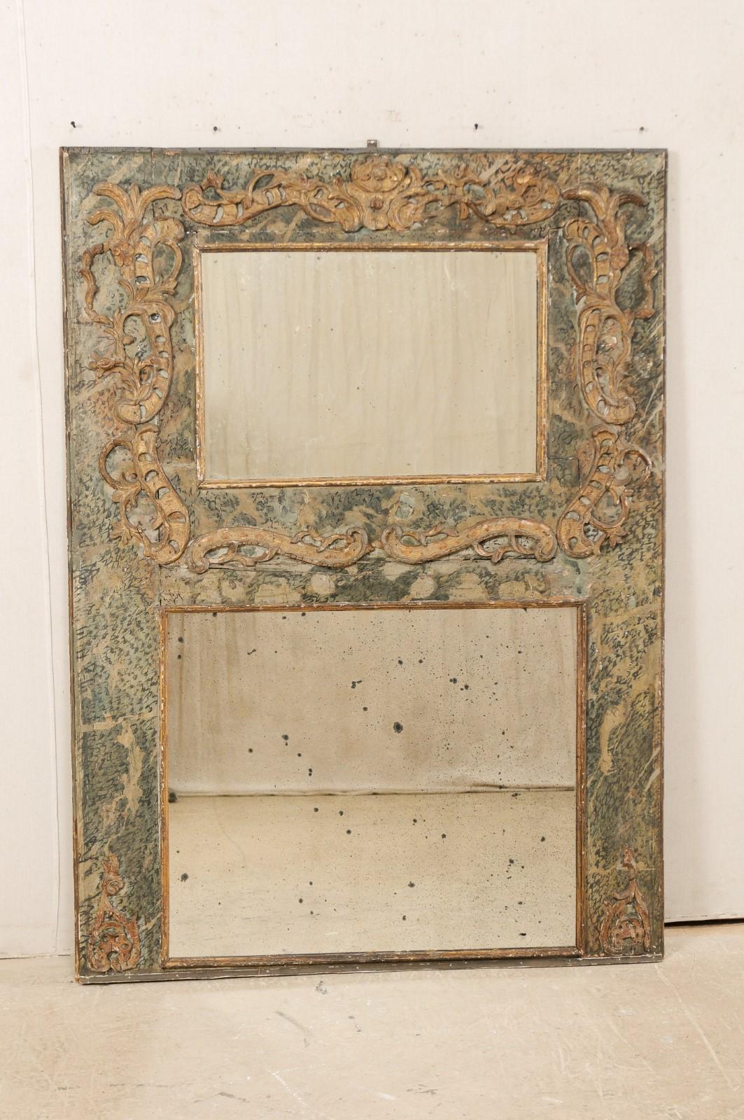 An Italian period Baroque mirror from the turn of the 17th and 18th century. This antique trumeau style mirror from Italy features a rectangular-shaped frame, which retains it's original or early paint, and two mirrors (top mirror slightly smaller