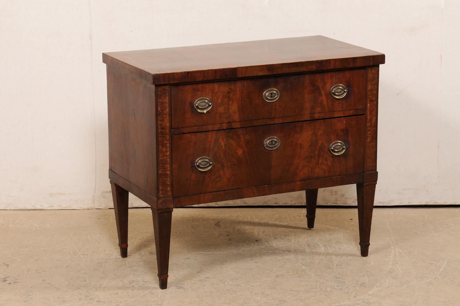 An Italian raised chest, with matchbook veneers, circa 1960's. This mid-century chest from Italy features a rectangular-shaped, matchbook veneer top, over a chase which houses a pair of stacked, graduated and dove-tailed drawers, and raised nicely