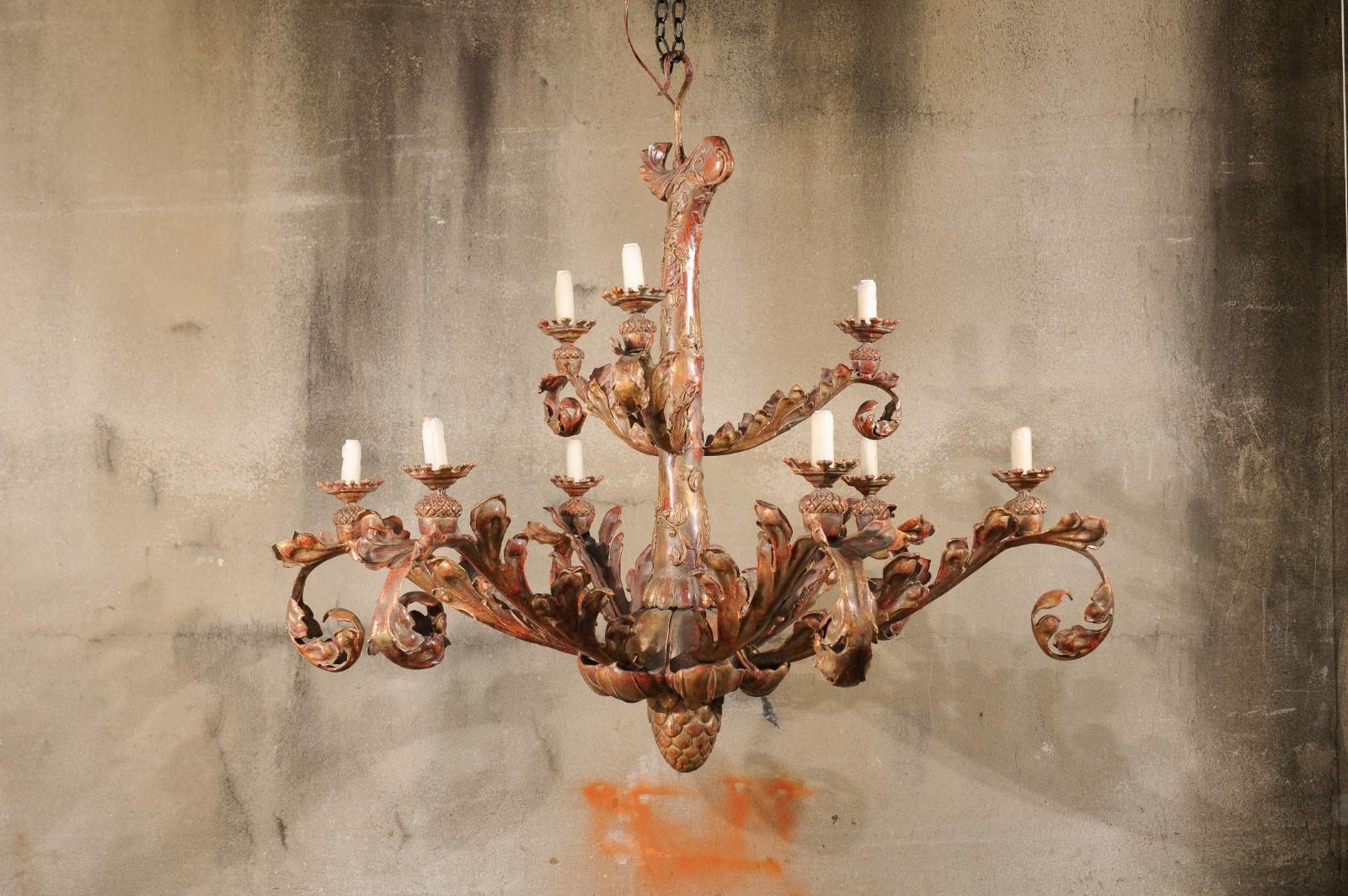 An elegant and large-sized Italian Renaissance-style two-tier chandelier. This vintage painted iron chandelier from Italy has a beautifully adorn central column body with two tiers of scrolling acanthus leaf designed arms (nine in total) curling