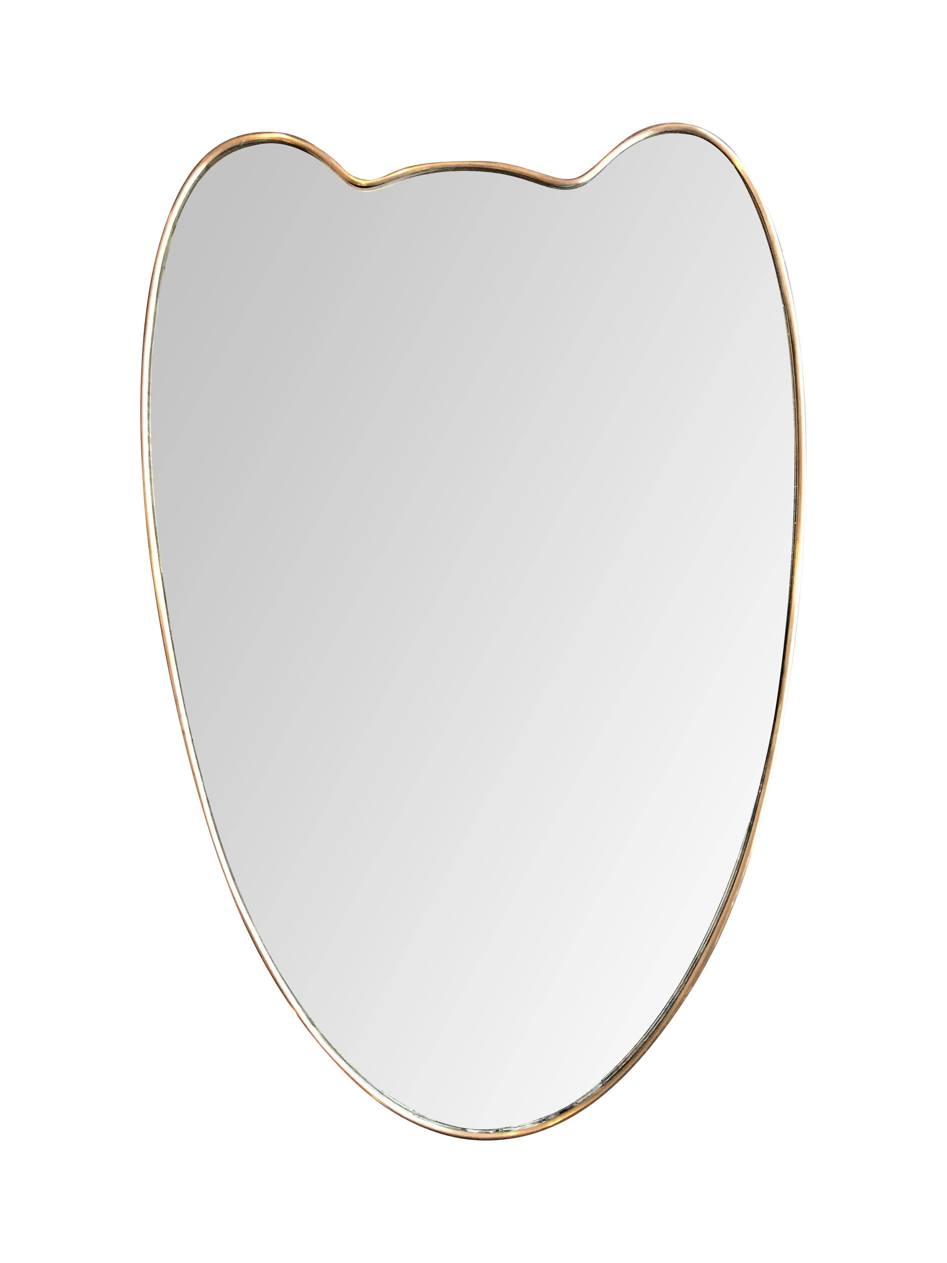 An Italian shield mirror with brass frame and solid wood back. Slight foxing on the original mirror consistent with age.