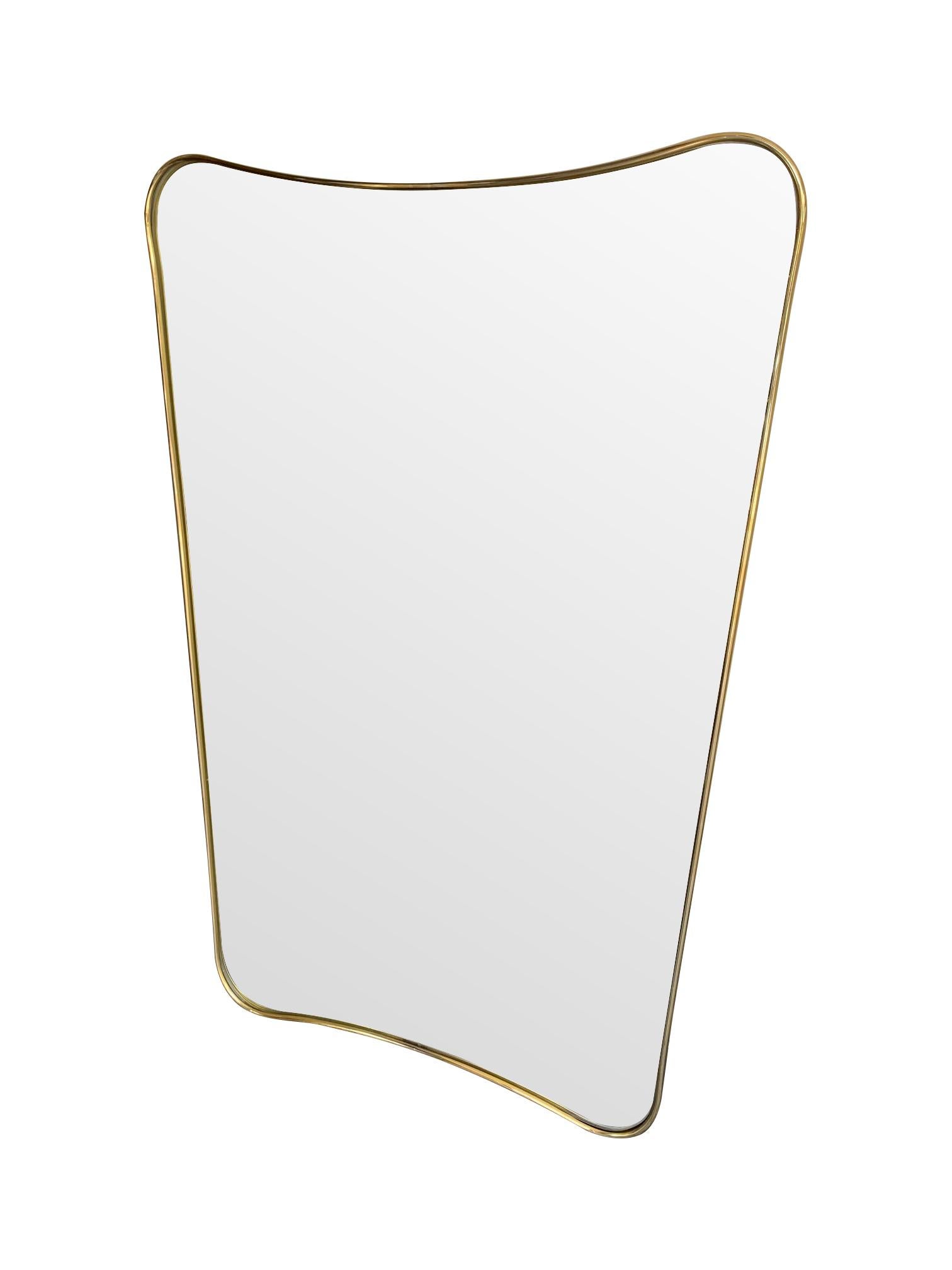 An Italian shield mirror with brass surround in the style of Gio Ponti with curved and tapered frame.

These are made to order in Italy and take 4-6 weeks to make and deliver to London. Two other sizes are 145cm high and 161cm high.