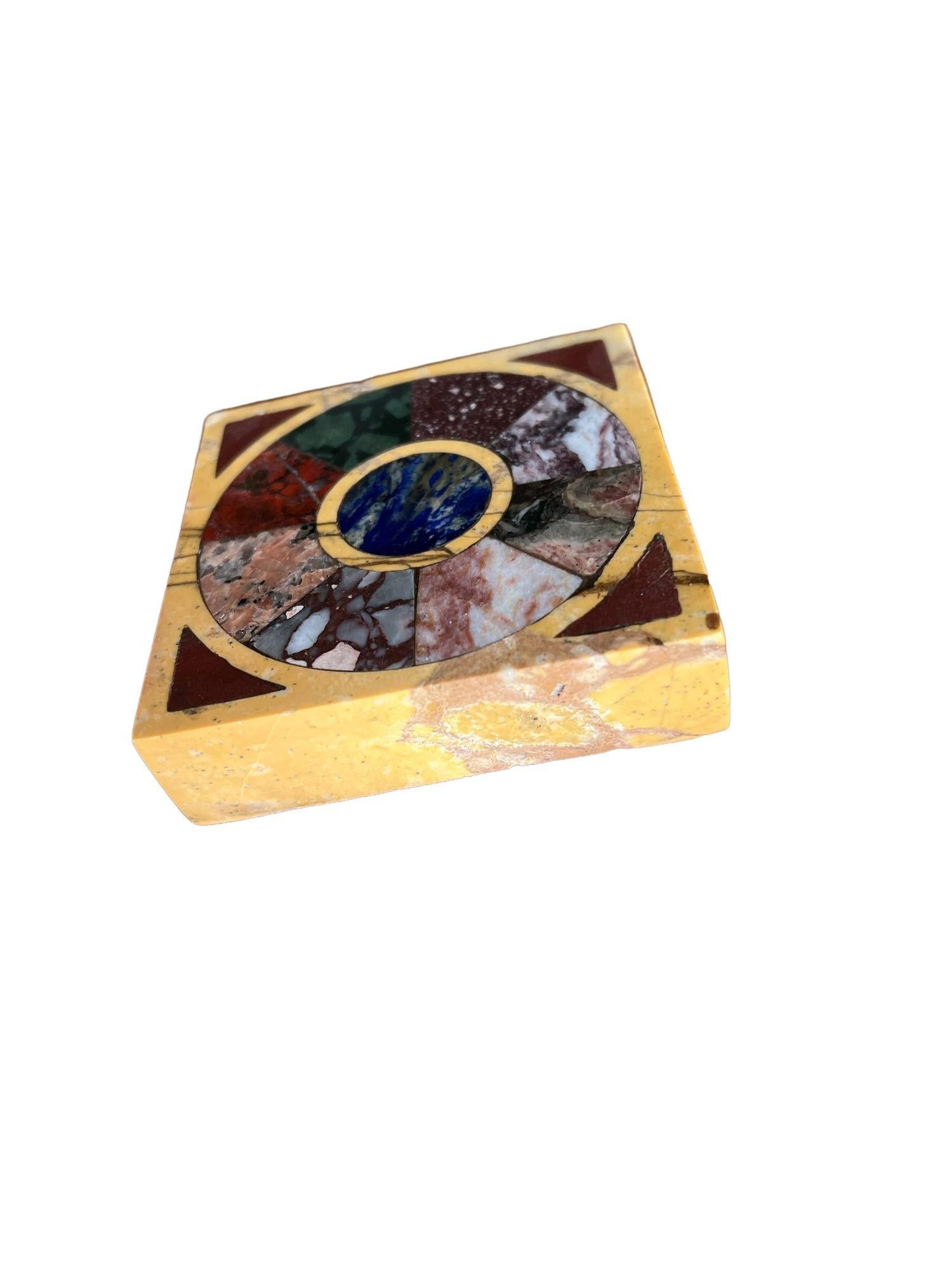 The square paperweight with specimen marbles inset in yellow marble ground.