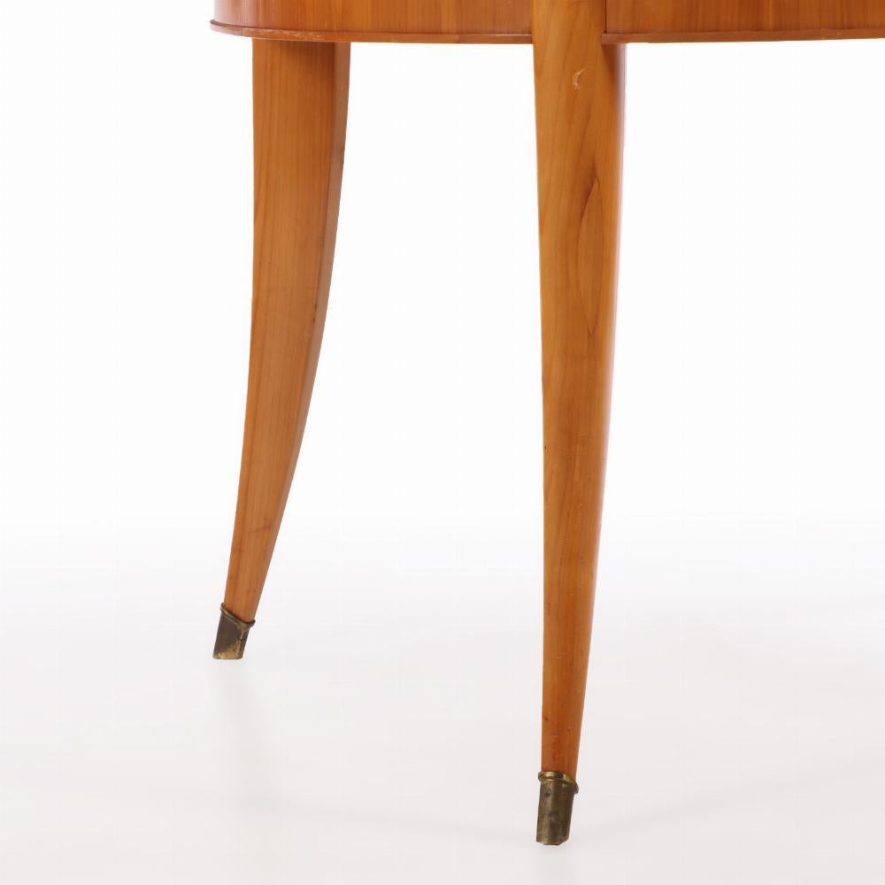 An elegant round Biedermeier style table with a radial top with a central dark 4 pointed star, all supported by curved legs ending in brass sabots.