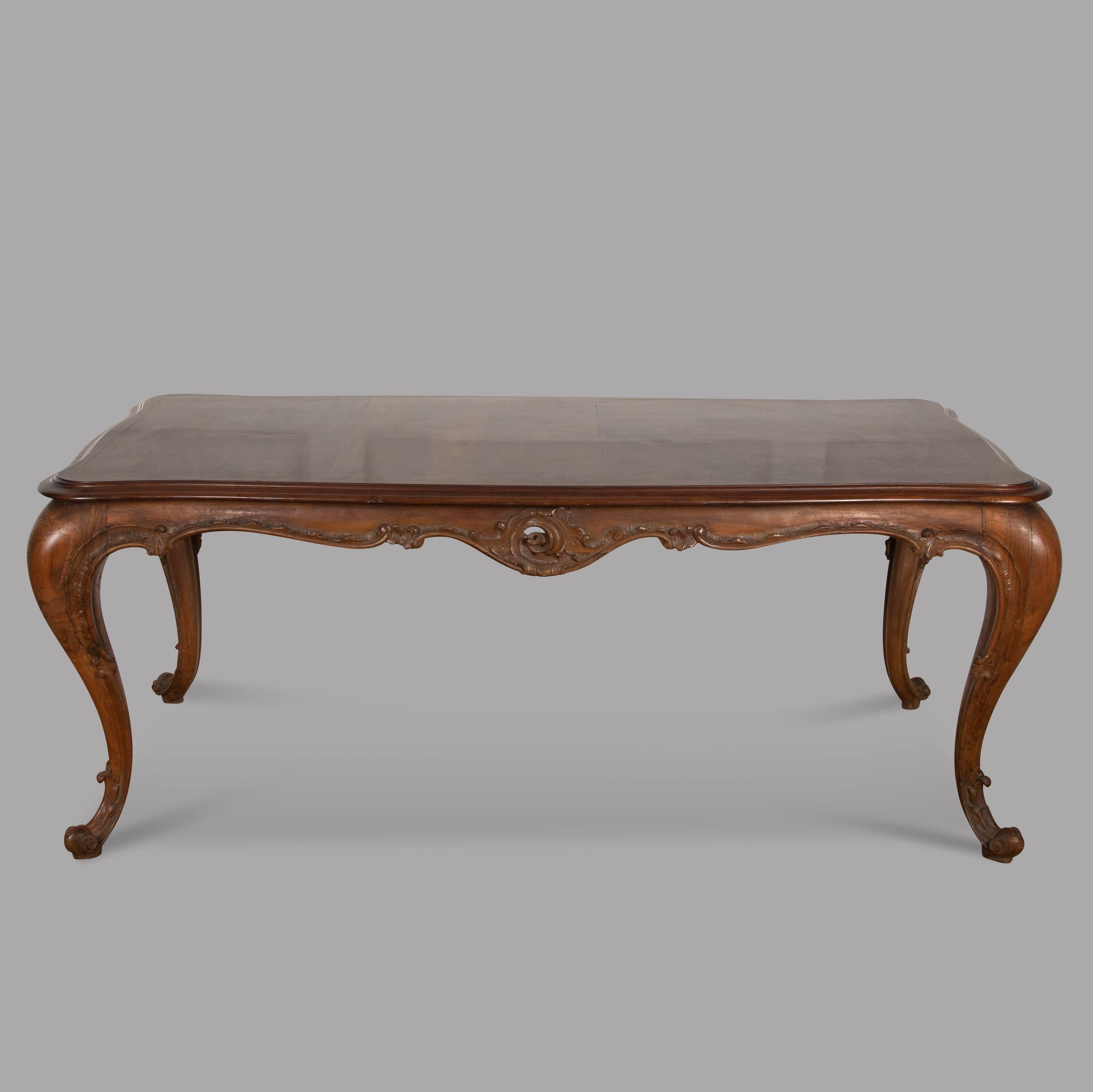 An attractive French walnut table with carved freize sides and cabriole carved legs, will seat eight comfortably.

Measures: length 200 cm, width 100 cm and height 78 cm.